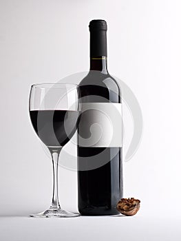 Glass of red vine with bottle