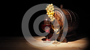 Glass of red , white wine and barrel on wooden table