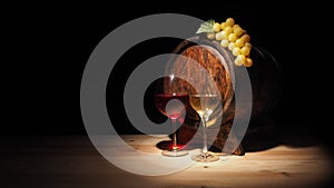 Glass of red , white wine and barrel on wooden table