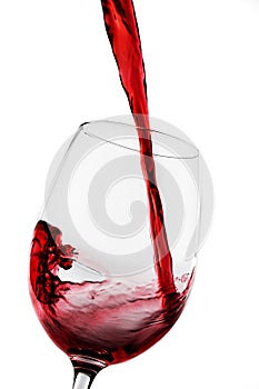 Glass of red wine being poured