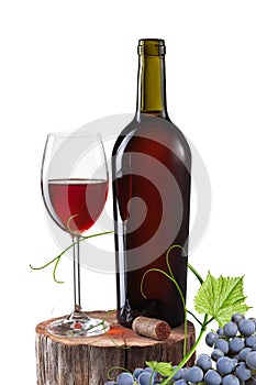 Glass of red wine, bottle and grape on stump isolated on white