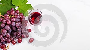 Glass of red wine and bunch of grapes on white background with copy space for text