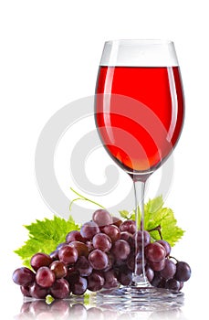 Glass of red wine and a bunch of ripe grapes isolated