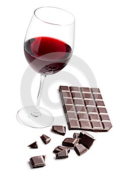 Glass with red wine and chocolate bar