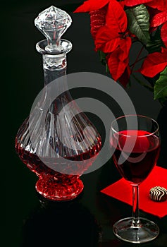 Glass of red wine and decanter