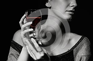 Glass with a red wine in a female hand