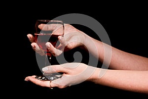 Glass with a red wine in a female hand