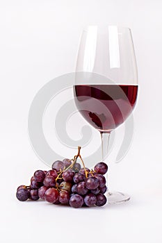 Glass Of Red Wine With Grapes Bunch