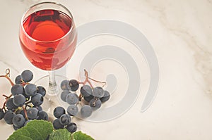 Glass of red wine and grapes/Glass of red wine and grapes on a white background , copy space