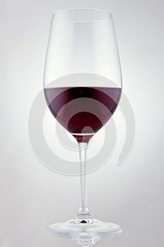 Glass of red wine in soft white light