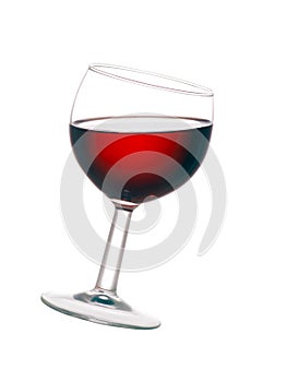 Glass of red wine, tilted, isolated on white background.