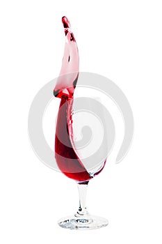 Glass of red wine up pouring, splash isolated on white