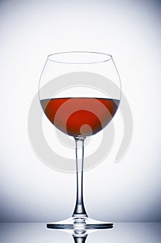 Glass of red wine on white