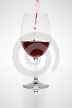 Glass with red wine on a white background