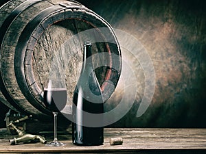 Glass of red wine and wine bottle. Oak wine keg at the background.