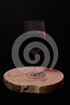 Glass of red wine on wooden stump