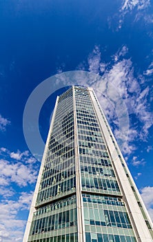 Glass reflective office buildings against blue sky