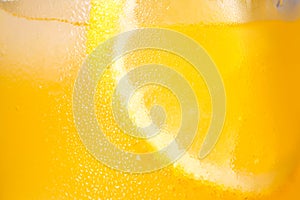 Glass of refreshing drink with sliced lemon on light background, closeup