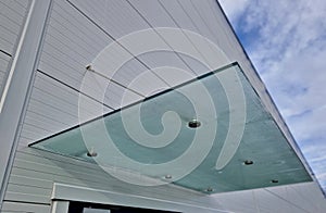 Glass roof above entrance industrial building with metal cladding