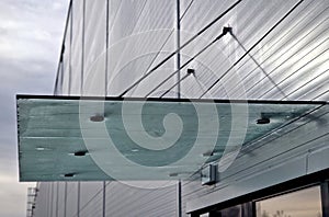 Glass roof above entrance industrial building with metal cladding