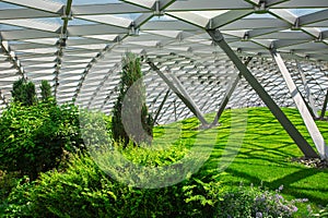 glass roof indoor safety park with green hill.