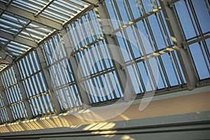 Glass roof in shopping mall. Details of interior in building. Light through glass. Dome in building