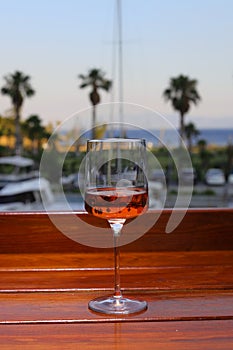 glass of rose or blush wine on the beach