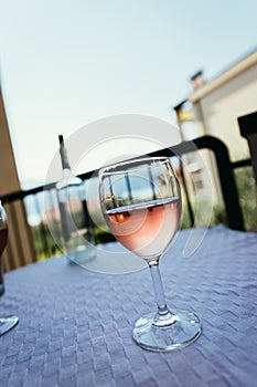 Enjoying a glass of rose wine on the veranda, summer holiday in Italy