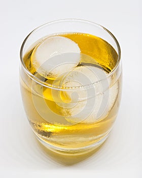 Glass with round ice cubes and apple juice