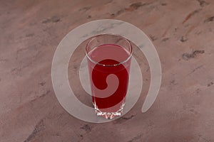 Glass of Salgam or fermented beet juice on brown background, selective focus. Popular Turkish drink. Traditional beverage made