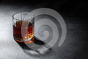 Glass of Scotch whiskey and ice on a dark background. place for text, top view