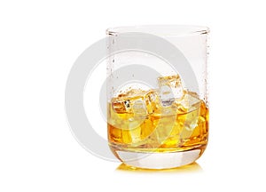 Glass of scotch whiskey and ice on a white background.