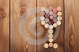 Glass shaped wine corks over rustic wooden table background