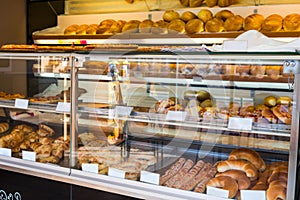 Glass shelves with fresh bread and buns