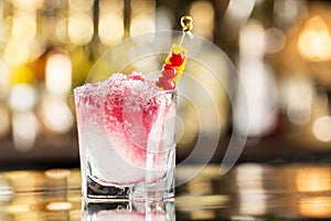 Glass of shirley temple cocktail decorated with cherry photo