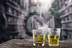 Glass shots with yellow liqour resembling whiskey