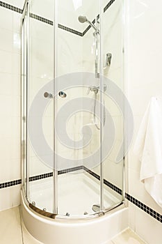 Glass shower cabin in modern bathroom