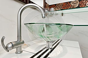Glass sink bowl in modern bathroom