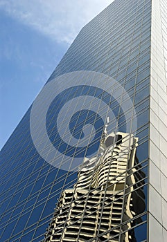 Glass skyscraper tall modern building, reflection, blue sky, copy space, front view