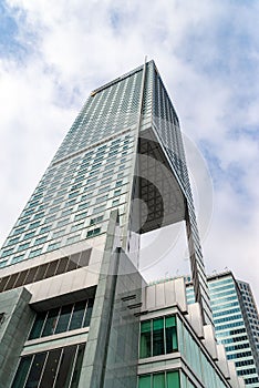 Glass skyscrapers of irregular shape. Bottom view. Abstract architectural detail of corporate building suitable as