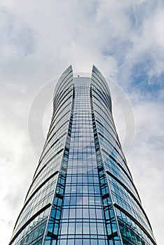 Glass skyscrapers of irregular shape. Bottom view. Abstract architectural detail of corporate building suitable as background