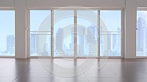 Glass sliding doors on tile floor in empty room with blurred cityscape view in blue sky background