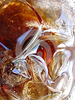 A glass of soda with ice cubes in it photo