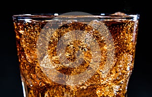 Glass with soft cola drink, ice and bubles