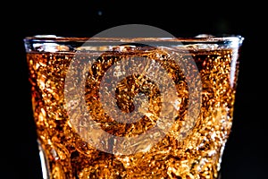 Glass with soft cola drink, ice and bubles