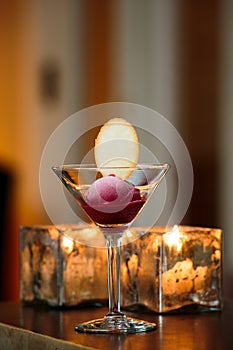 A glass with sorbet and a cookie served during a fancy wedding