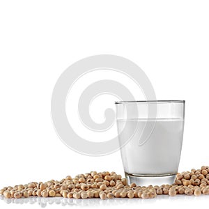 Glass of soymilk and soybean on white .