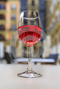 Glass of Spanish rose or rosado in a restaurant on a square in Pamplona, Spain photo