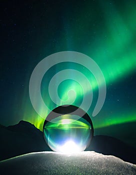 A glass sphere in front of northern light