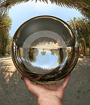 Glass sphere in hand. Vai. Crete